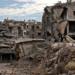 Destroyed buildings are pictured at the Palestinian Yarmuk camp, on the southern outskirts of the Syrian capital Damascus, on November 25, 2020 as families visit the destroyed residential district to inspect their abandoned apartments and register with the authorities with the hope of eventually returning to their homes. - In May 2018, the Syrian government retook the Palestinian camp of Yarmuk and adjacent suburbs after a pulverising assault that lasted nearly a month to expel jihadists who controlled the area for years. That placed the regime in full control of the entire capital for the first time since 2012. Yarmuk is a camp turned into a bustling neighbourhood before the seven-year civil war in Syria, with most of its residents of Palestinian origin. (Photo by LOUAI BESHARA / AFP)