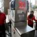 A female employee works alongside a male colleague at a petrol station in Cairo, Egypt, February 24, 2016. A petrol station in the Egyptian capital Cairo hires women to work as attendants - until now, petrol stations were staffed almost exclusively by men. Picture taken February 24, 2016. REUTERS/Mohamed Abd El Ghany      TPX IMAGES OF THE DAY