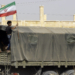 A Syrian boy holds the Iranian flag as a truck carrying aid provided by Iran arrives in the eastern city of Deir Ezzor on September 20, 2017 while Syrian government forces continue to press forward with Russian air cover in the offensive against Islamic State group jihadists across the province.
Two separate offensives are under way against the jihadists in the area -- one by the US-backed Syrian Democratic Forces, the other by Russian-backed government forces. The Syrian army now controls around 70 percent of the city and is battling to oust IS from the remainder, according to the Britain-based Observatory.
 / AFP PHOTO / LOUAI BESHARA        (Photo credit should read LOUAI BESHARA/AFP via Getty Images)