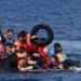 Syrian and Afghan refugees fall into the sea after their dinghy deflated some 100m away before reaching the Greek island of Lesbos, September 13, 2015. Of the record total of 432,761 refugees and migrants making the perilous journey across the Mediterranean to Europe so far this year, an estimated 309,000 people had arrived by sea in Greece, the International Organization for Migration (IMO) said on Friday. About half of those crossing the Mediterranean are Syrians fleeing civil war, according to the United Nations refugee agency. REUTERS/Alkis Konstantinidis      TPX IMAGES OF THE DAY      - RTSUQ8