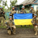 Ukrainian servicemen of the 35th Separate Brigade of Marines pose for a photograph with the Ukrainian flag in the liberated village of Storozheve, in Dontesk region, Ukraine, in the still image taken from a social media video released on June 12, 2023.   35th Separate Brigade of Marines via Facebook/via REUTERS    THIS IMAGE HAS BEEN SUPPLIED BY A THIRD PARTY