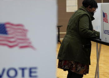 A woman votes at a voting site as Democrats and Republicans hold their Michigan primary presidential election, in Detroit, Michigan, U.S. February 27, 2024. REUTERS/Dieu-Nalio Chery