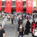 People wearing face masks as a protection against the coronavirus (Covid-19) walk in a street in Ankara on May 21, 21021. (Photo by Adem ALTAN / AFP)