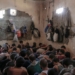 FILE - In this July 18, 2017 file photo, suspected Islamic State members sit inside a small room in a prison south of Mosul. The IS erupted from the chaos of Syria and Iraq's conflicts and swiftly did what no Islamic militant group had done before, conquering a giant stretch of territory and declaring itself a "caliphate." U.S. officials said late Saturday, Oct. 26, 2019 that their shadowy leader Abu Bakr al-Baghdadi was the target of an American raid in Syria and may have died in an explosion. (AP Photo/Bram Janssen, File)