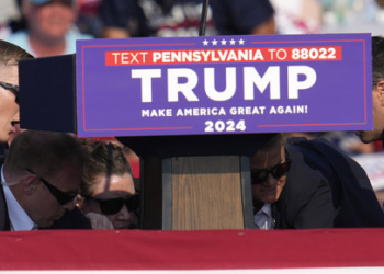 Members of the U.S. Secret Service surround Republican presidential candidate former President Donald Trump at a campaign event in Butler, Pa., on Saturday, July 13, 2024. (AP Photo/Gene J. Puskar)